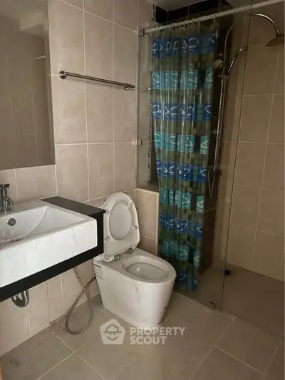 Modern bathroom with sleek fixtures and glass shower enclosure