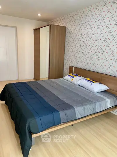 Cozy bedroom with modern wooden furniture and stylish wallpaper, perfect for relaxation.