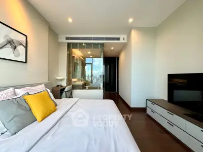 Luxurious modern bedroom with city view and stylish decor in high-rise apartment.