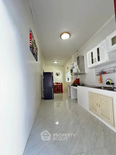 Spacious kitchen with modern appliances and dining area in a bright, open layout.