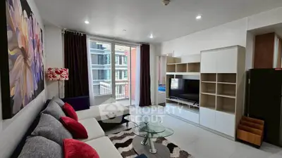 Modern living room with stylish decor and balcony access in a contemporary apartment.