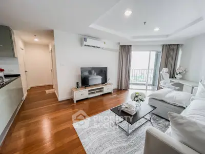 Modern living room with sleek furniture and balcony access in a stylish apartment.