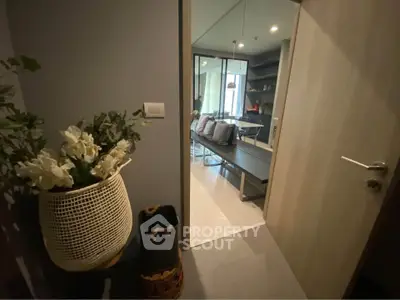 Modern apartment entrance leading to a cozy living area with stylish decor.