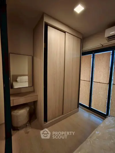 Modern bedroom with built-in wardrobe and natural light
