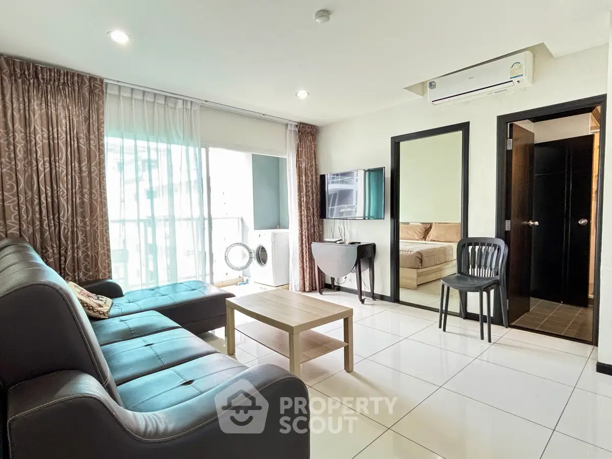 Spacious modern living room with sleek furniture and large windows for natural light.