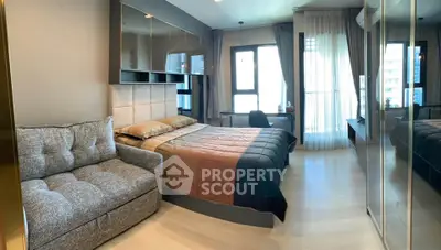 Modern bedroom with cozy sofa and large windows in a stylish apartment