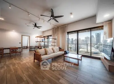 Spacious modern living room with city view and wooden flooring