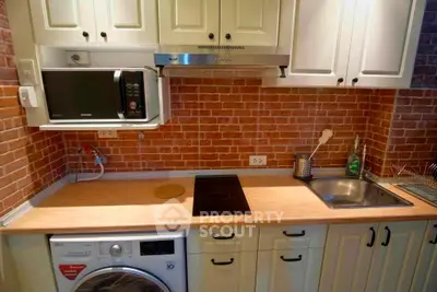 Charming kitchen with brick backsplash, modern appliances, and wooden countertops for a cozy cooking experience.