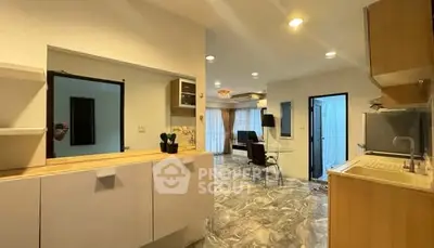 Spacious open-plan kitchen and living area with modern furnishings and ample natural light.