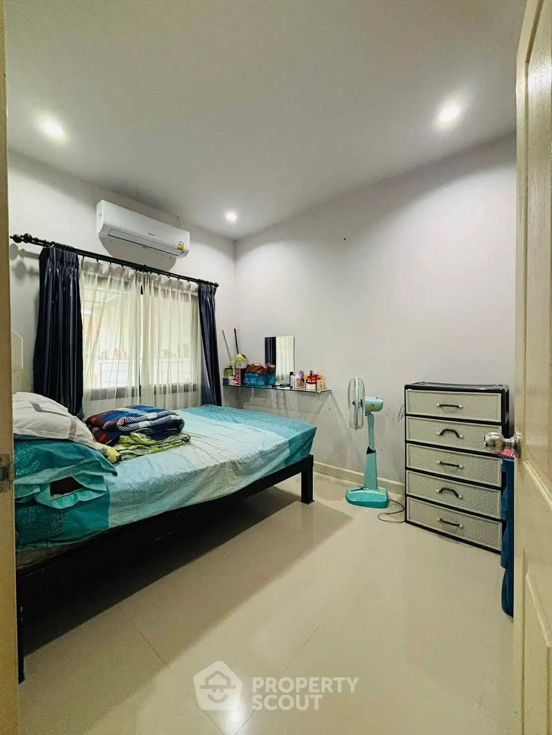 Cozy bedroom with modern decor and ample natural light