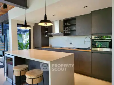 Modern kitchen with sleek design, island seating, and open layout in luxury home.