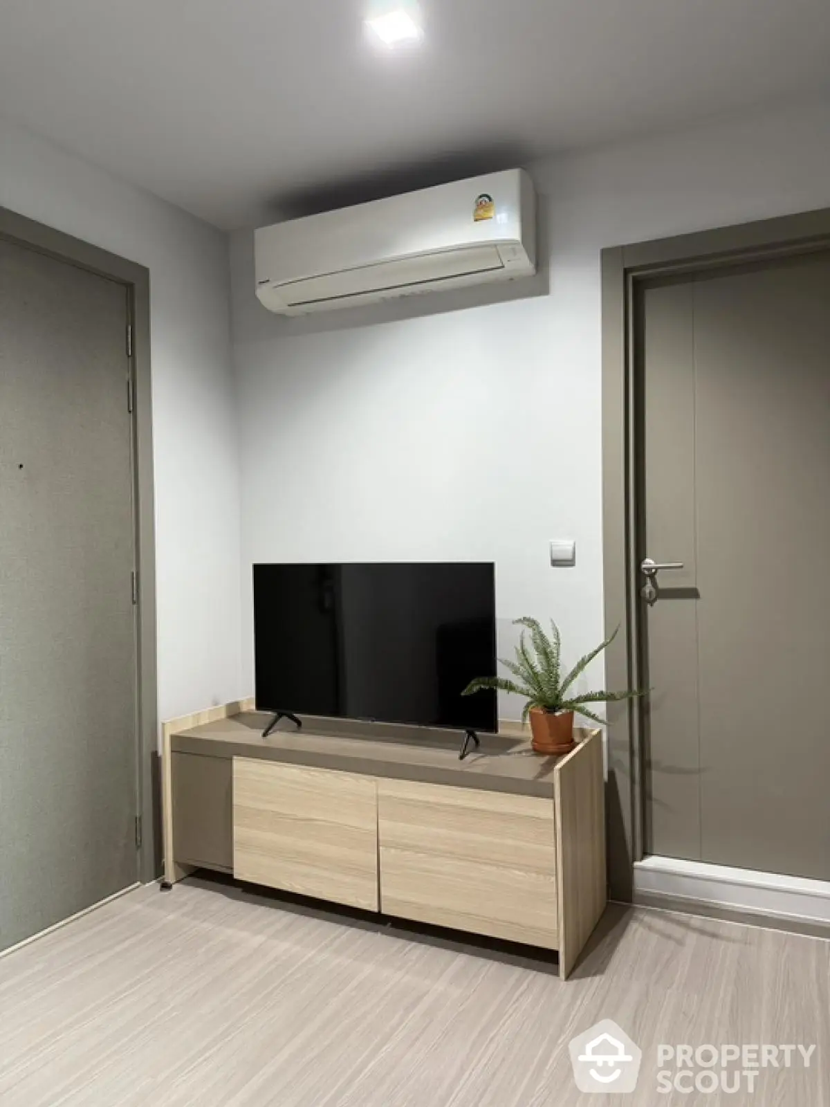 Modern living room with sleek TV stand and air conditioning unit