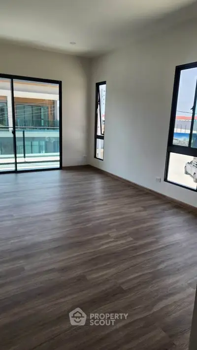 Spacious corner unit with large windows and modern flooring