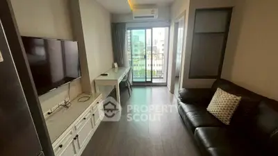 Modern living room with balcony view, sleek furniture, and natural light in urban apartment.