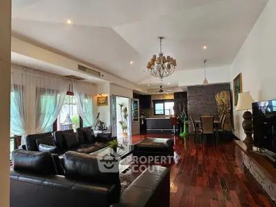 Spacious living room with elegant decor and open kitchen layout, perfect for modern living.