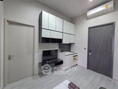 Modern compact living room with sleek cabinetry and air conditioning