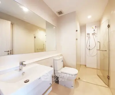 Modern bathroom with glass shower and sleek fixtures