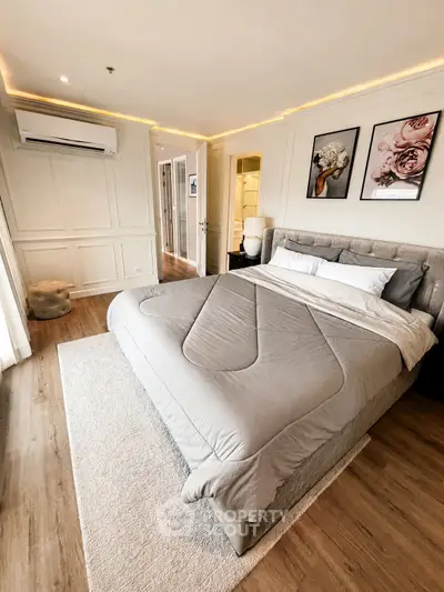 Luxurious bedroom with modern decor and elegant lighting in a stylish apartment.