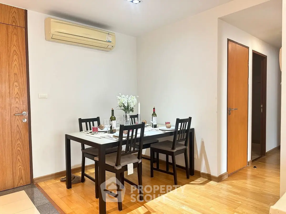 Cozy dining area with wooden flooring and modern table setting