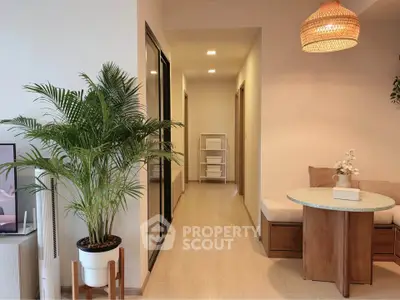 Modern living room with stylish furniture and indoor plant, showcasing cozy and inviting ambiance.