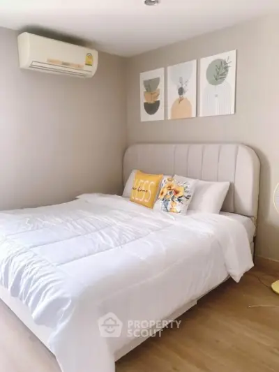 Cozy bedroom with modern decor and air conditioning, perfect for relaxation and comfort.