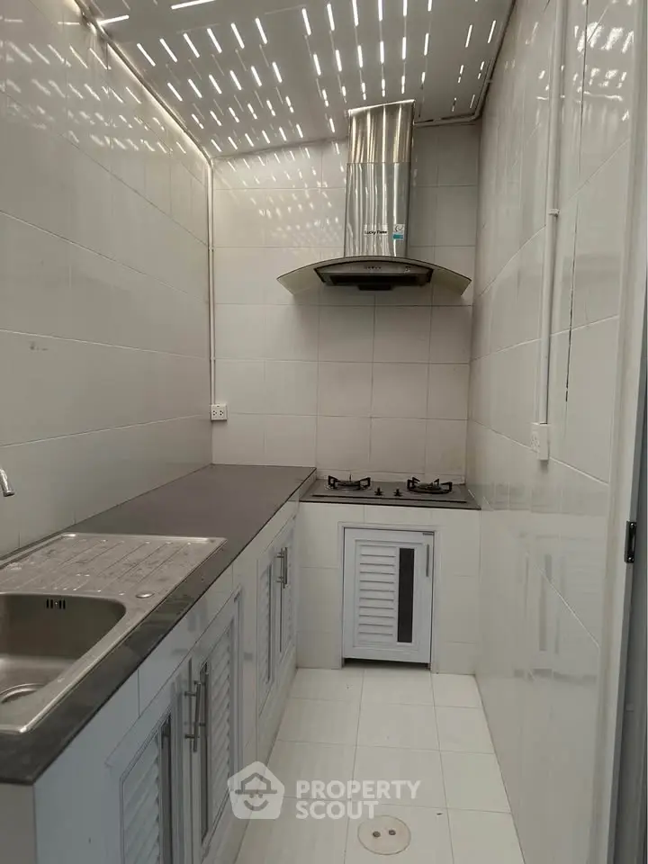 Modern compact kitchen with gas stove and sleek cabinetry