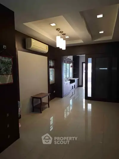 Spacious modern living room with sleek design and ample natural light.