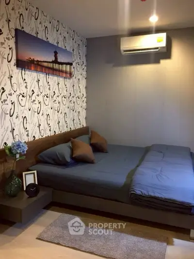 Cozy bedroom with modern decor and air conditioning in stylish apartment.