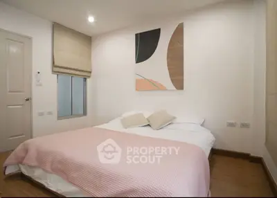 Cozy bedroom with modern decor and soft lighting, perfect for relaxation.