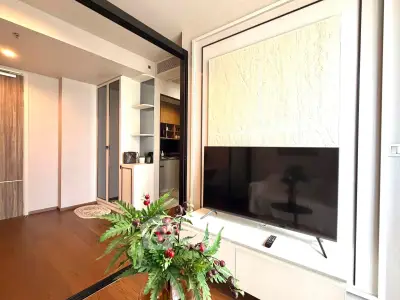 Modern living room with sleek TV setup and stylish decor in a contemporary apartment.