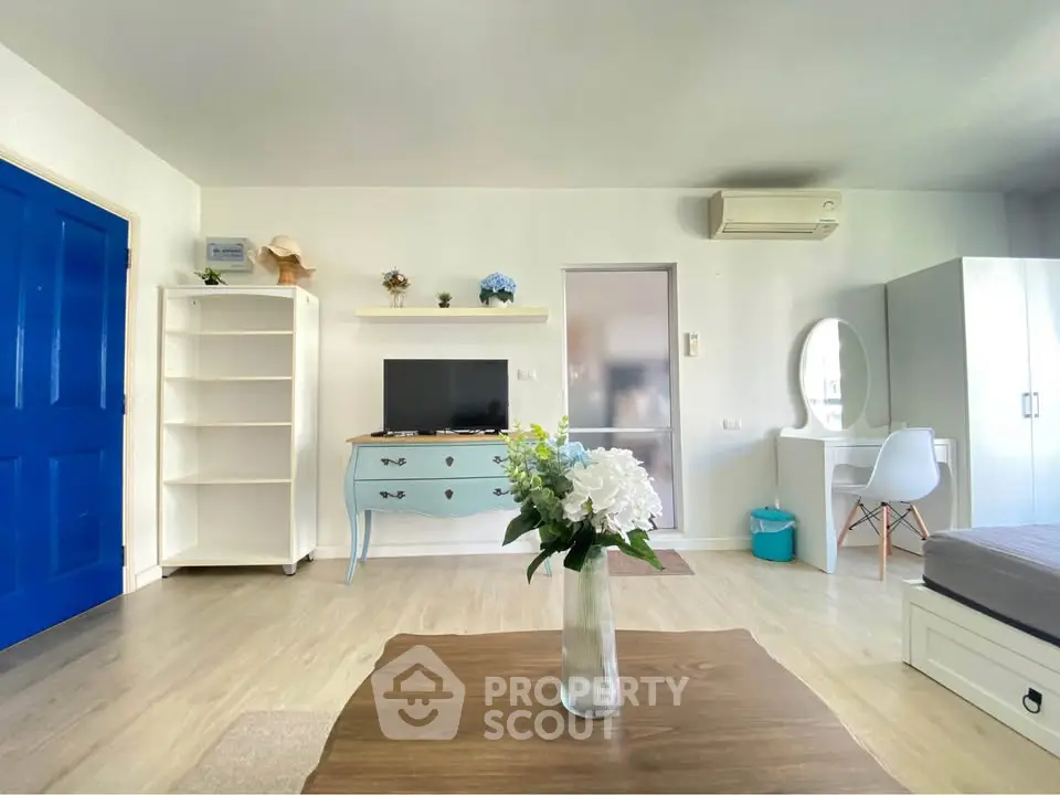 Bright and airy living room with modern decor and air conditioning, perfect for relaxation.