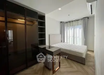 Modern bedroom with sleek furniture and large window for natural light