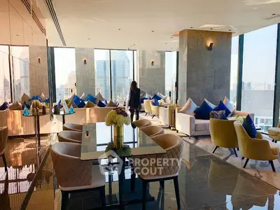 Luxurious high-rise living room with panoramic city views and elegant modern furnishings.
