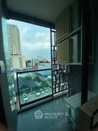 Modern high-rise balcony with city view and laundry area