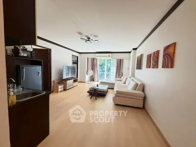 Spacious living room with modern decor and large windows offering natural light.