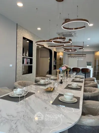 Luxurious dining room with elegant marble table and modern lighting fixtures
