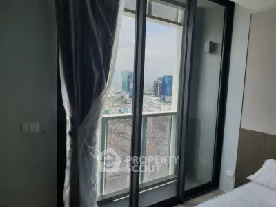 Luxurious bedroom with floor-to-ceiling windows offering stunning city views in a modern high-rise apartment.