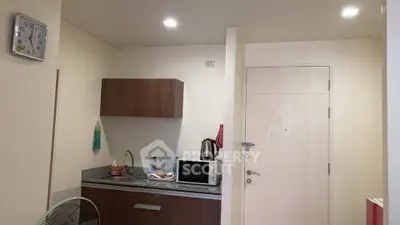 Compact kitchen with modern appliances and minimalist design
