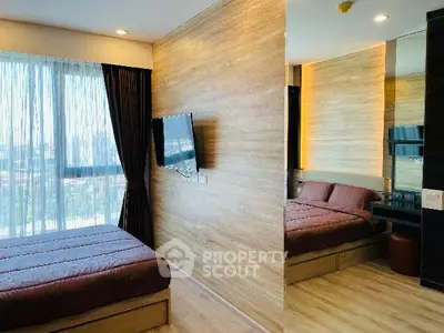 Modern bedroom with large window and wall-mounted TV in stylish apartment.