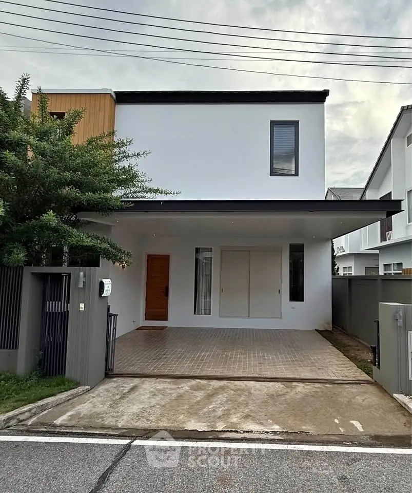 Modern two-story house with minimalist design and spacious driveway