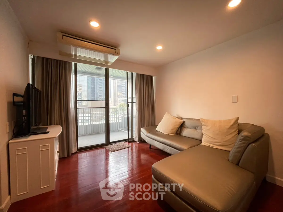 Spacious living room with modern sofa and balcony view