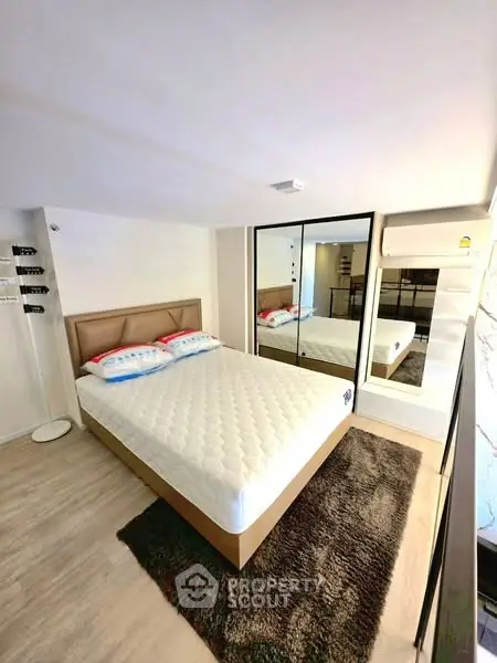 Modern bedroom with mirrored wardrobe and cozy decor