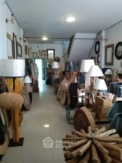 Spacious interior showcasing unique wooden furniture and decor in a modern showroom setting.