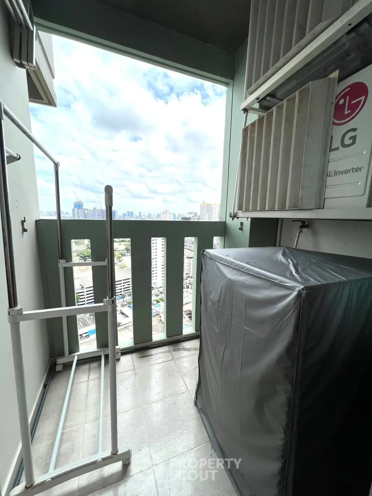 High-rise balcony with city view and LG inverter air conditioning unit.