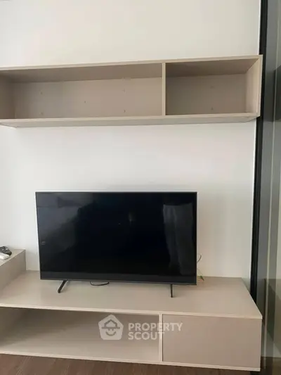 Modern living room with sleek TV setup and minimalist shelving