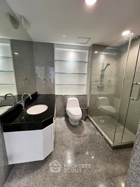 Modern bathroom with glass shower and sleek fixtures