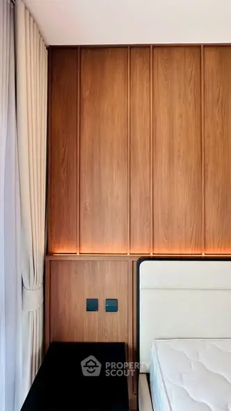 Modern bedroom with wood paneling and elegant lighting