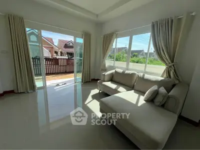 Spacious living room with large windows and garden view in modern home