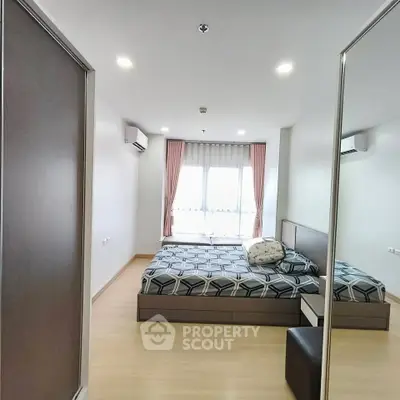 Modern bedroom with stylish decor and ample natural light