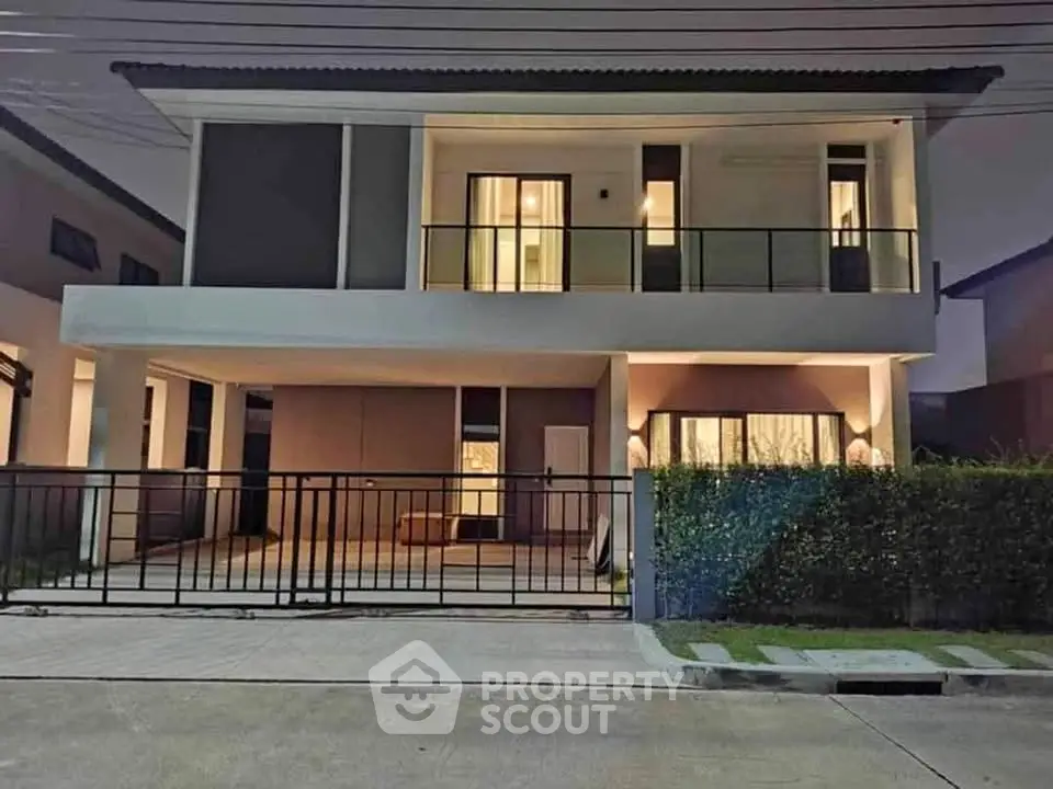 Modern two-story house with spacious balcony and sleek exterior design